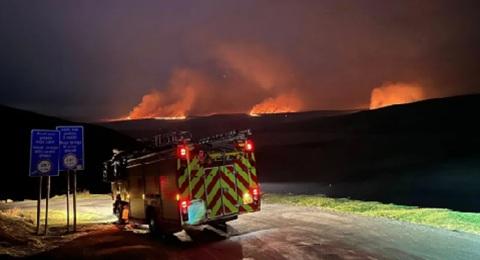 Firefighters have entered their fourth day tackling wildfires spreading across a mid-Wales UK beauty spot.