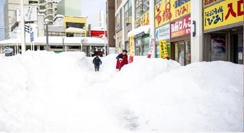 Record-breaking snow blankets Japan, killing at least 30 people